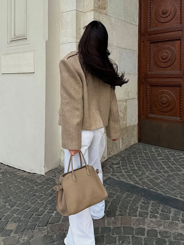 Langry fashion beige textured handbag with dual handles on large collared coat