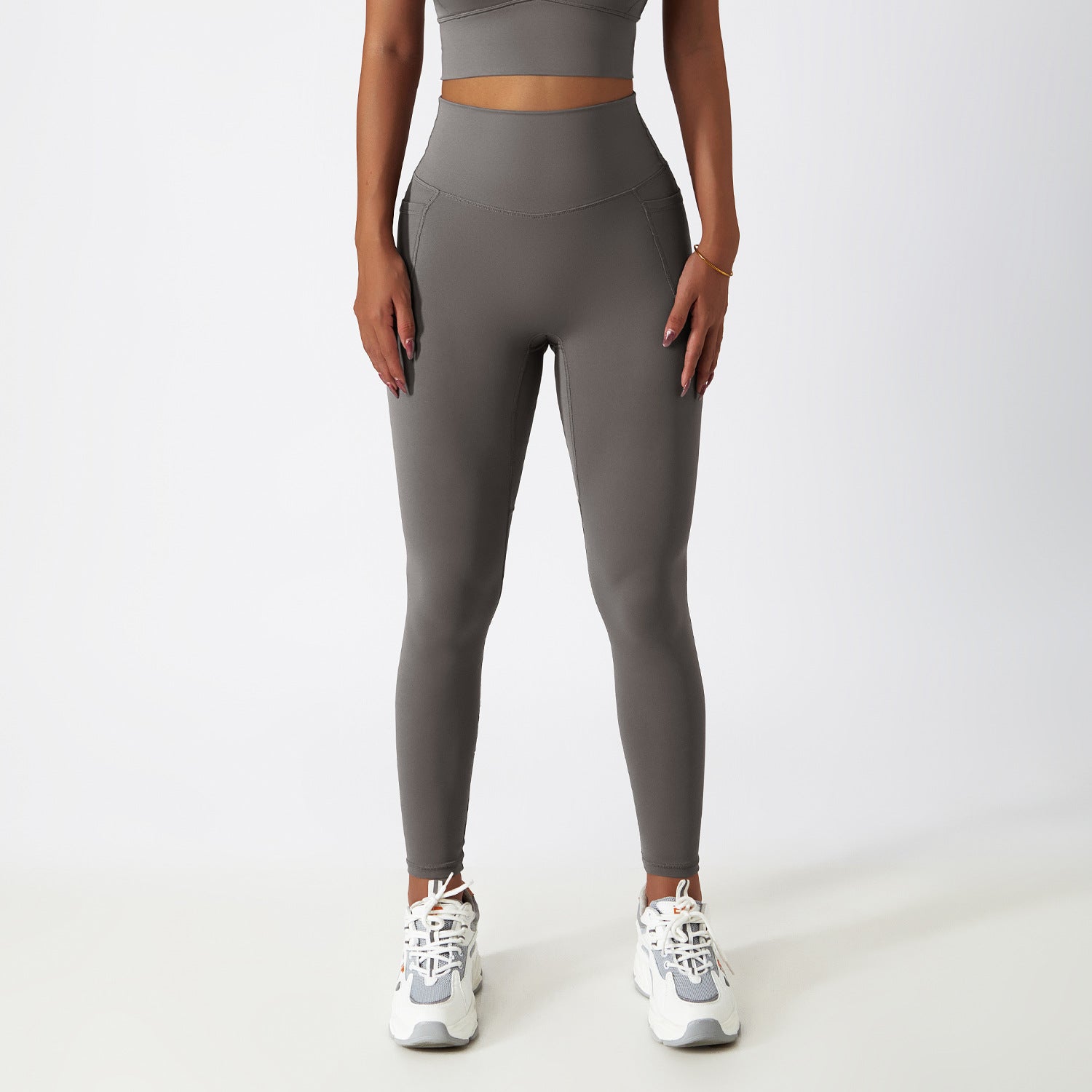 High-waisted grey athletic leggings and white sneakers for stylish activewear fashion