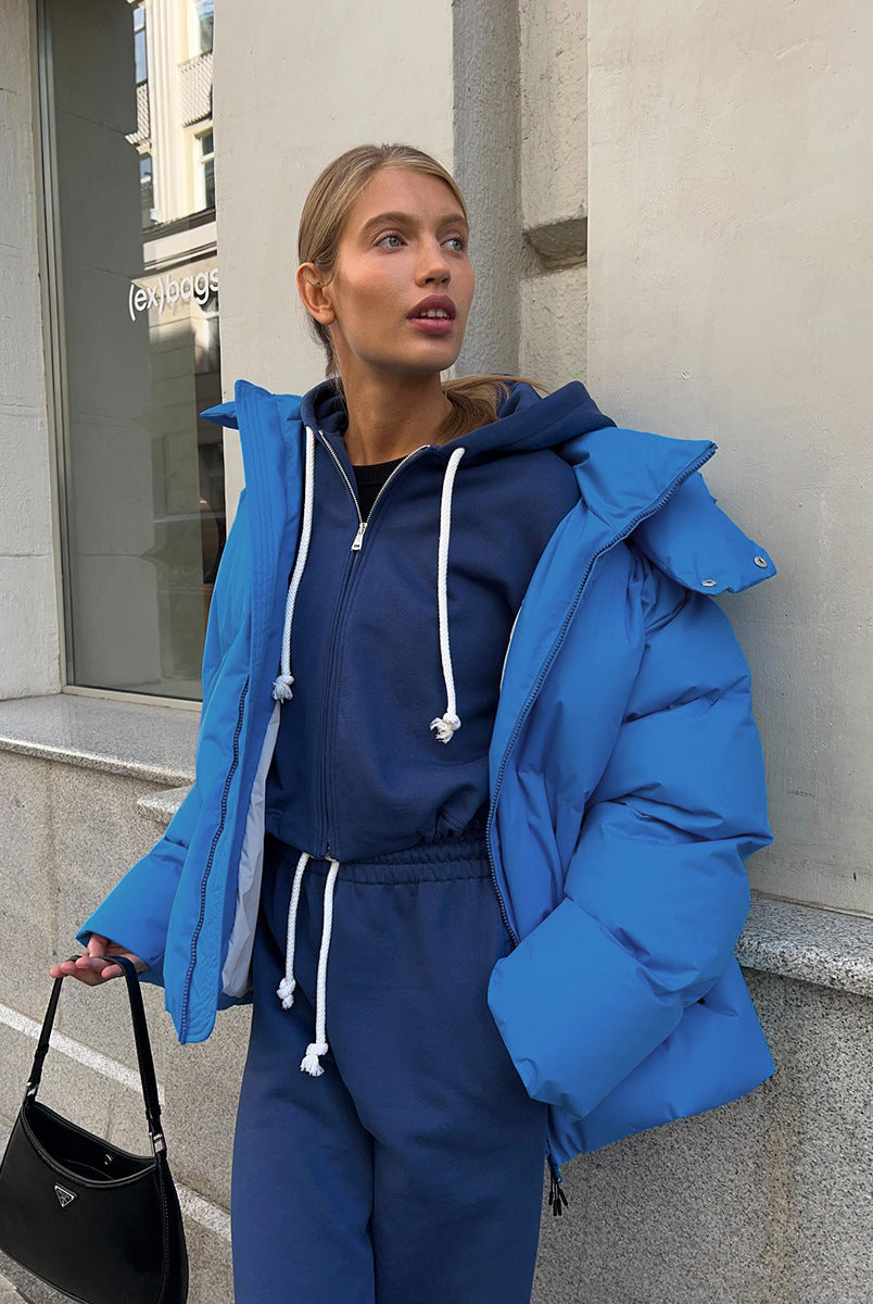 Woman in blue puffer jacket and matching tracksuit showcasing Langry fashion ملابس