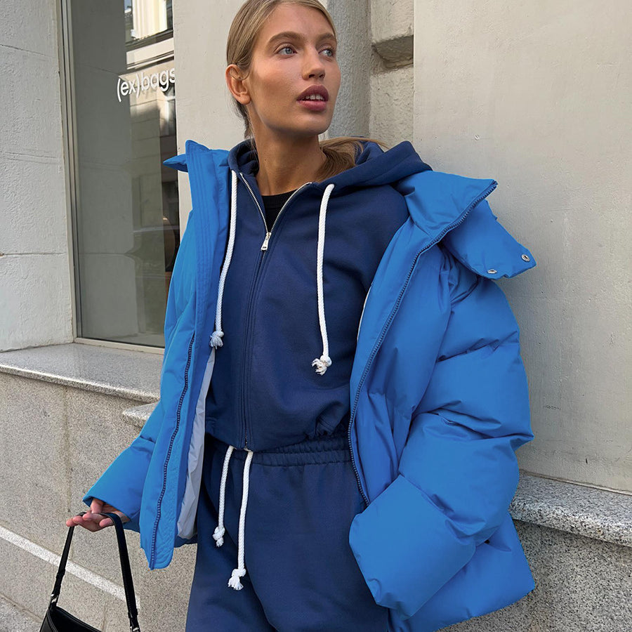 Woman in blue puffer jacket and matching tracksuit showcasing Langry fashion ملابس