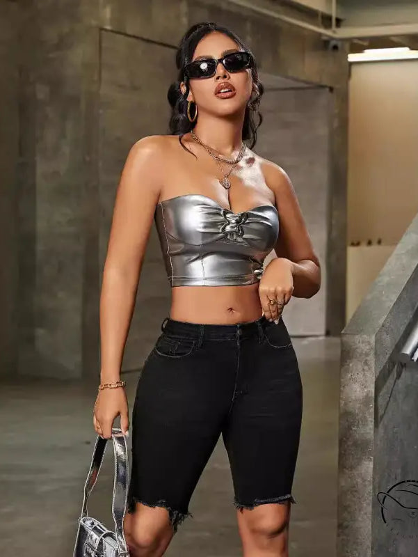 Silver strapless crop top with front tie, paired with denim shorts high waist