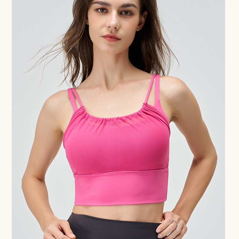 Woman in pink sports bra wearing CUTE PLEATED MESH YOGA VEST in Cherry Blossom Powder