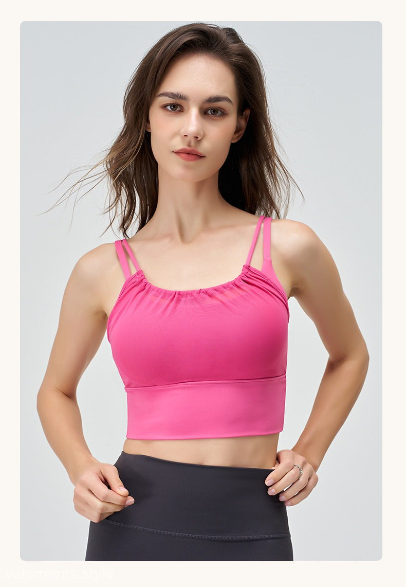 Woman in pink sports bra wearing CUTE PLEATED MESH YOGA VEST in Cherry Blossom Powder