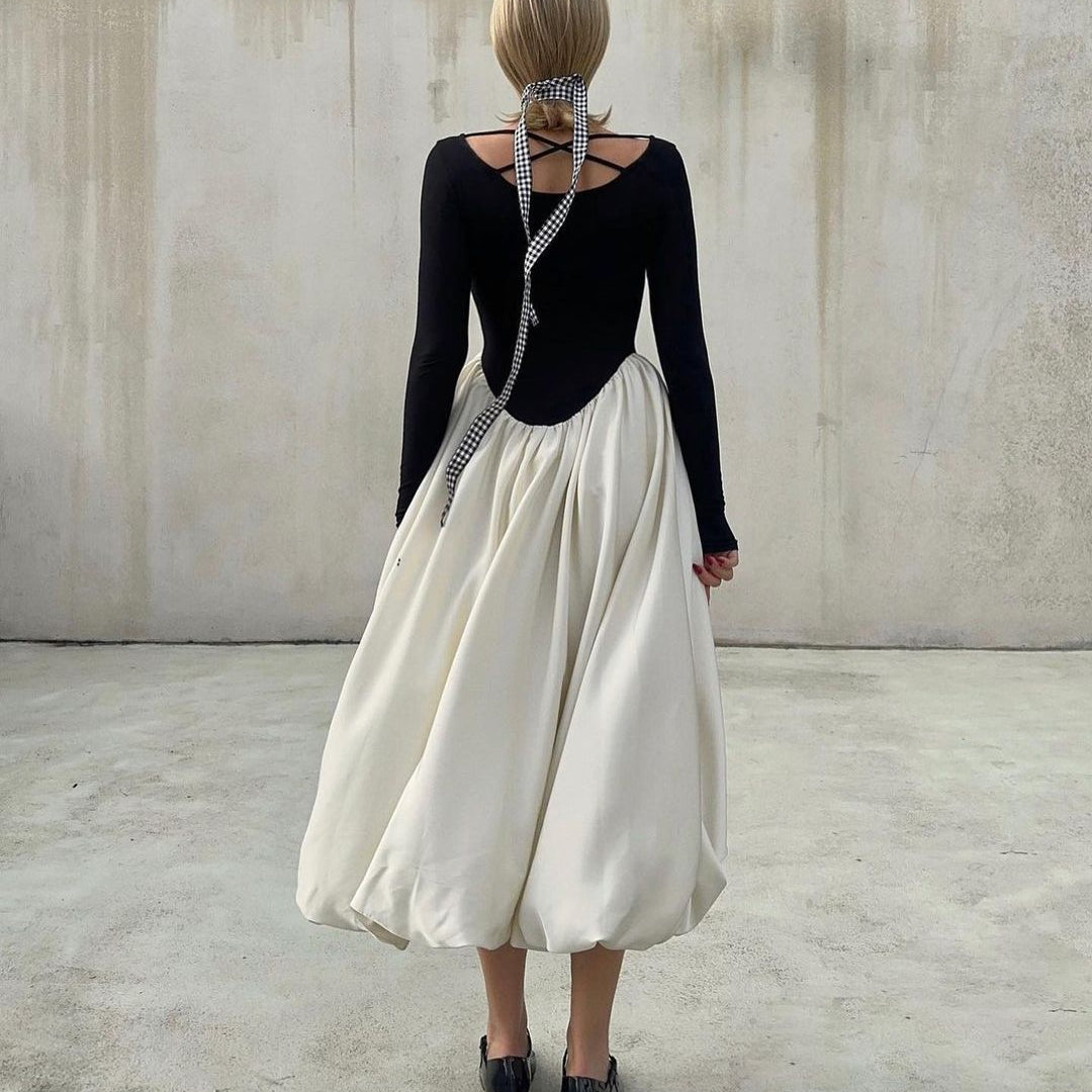 Elegant Hepburn Dress featuring a black long-sleeved top and flowing white midi bubble skirt