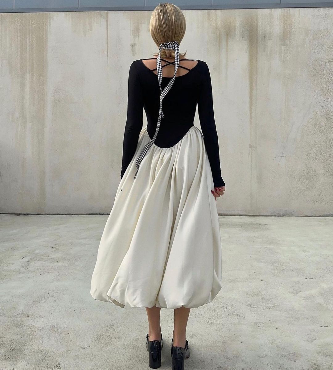 Elegant Hepburn Dress featuring a black long-sleeved top and flowing white midi bubble skirt
