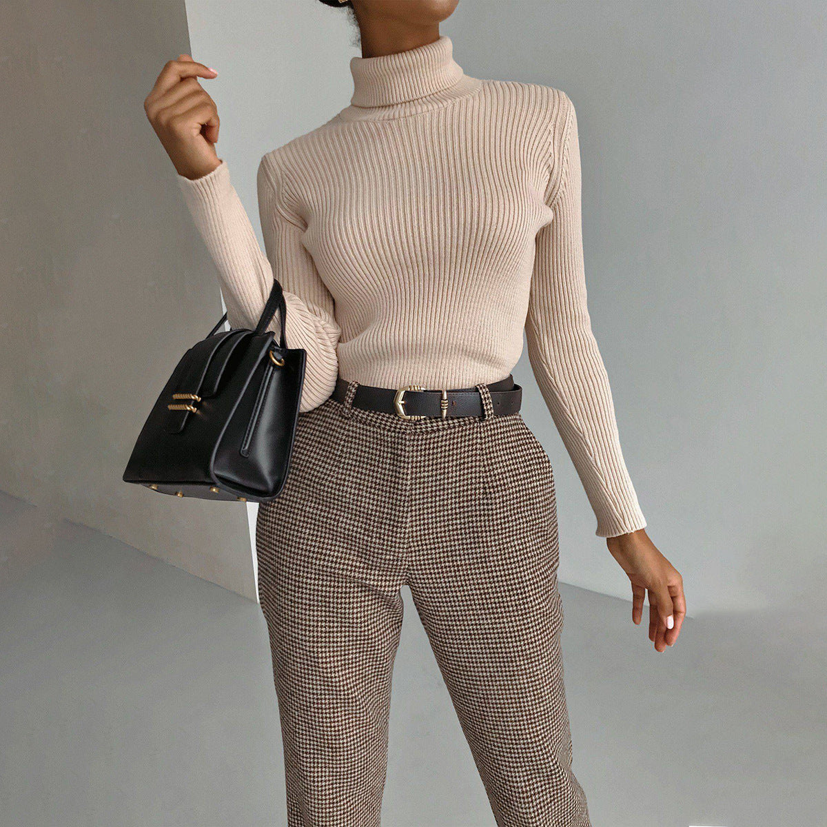 Beige ribbed Langry fashion turtleneck sweater with black belt and plaid pants