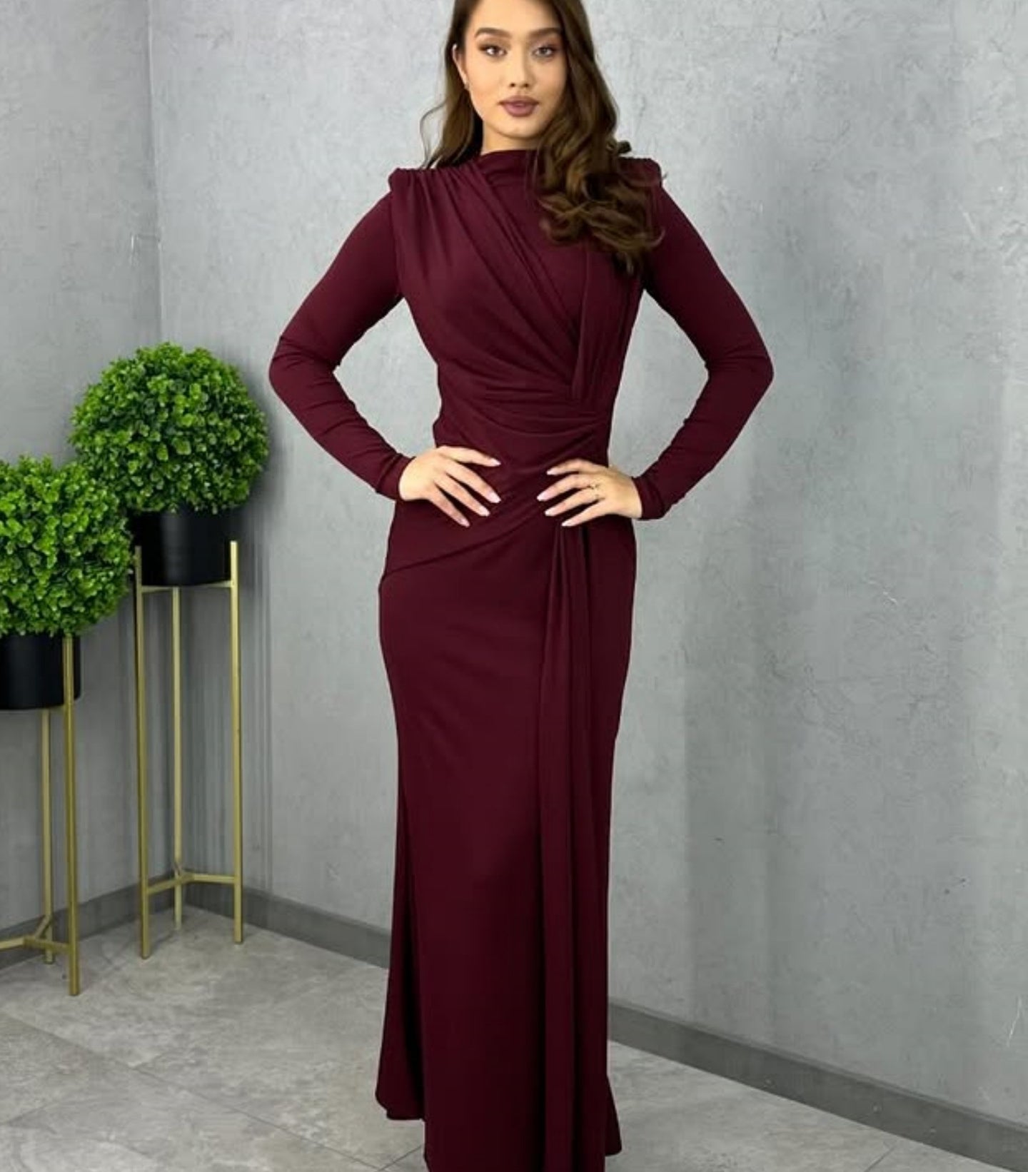 Sleek maroon maxi dress with high neckline and draped waist detailing