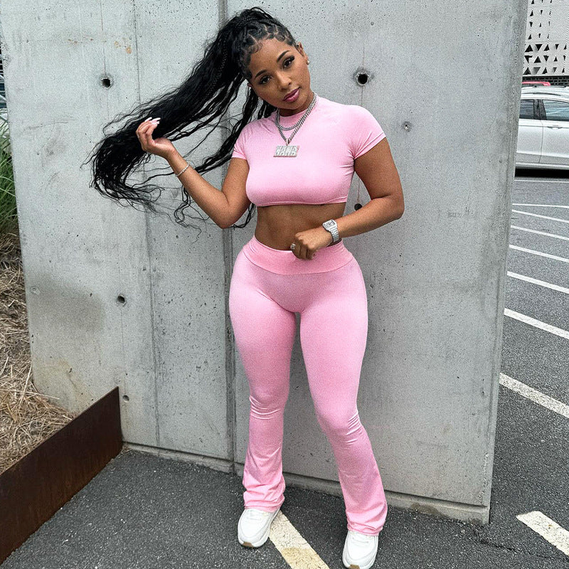 Woman in pink crop top and pants wearing the slim fit high waist suit