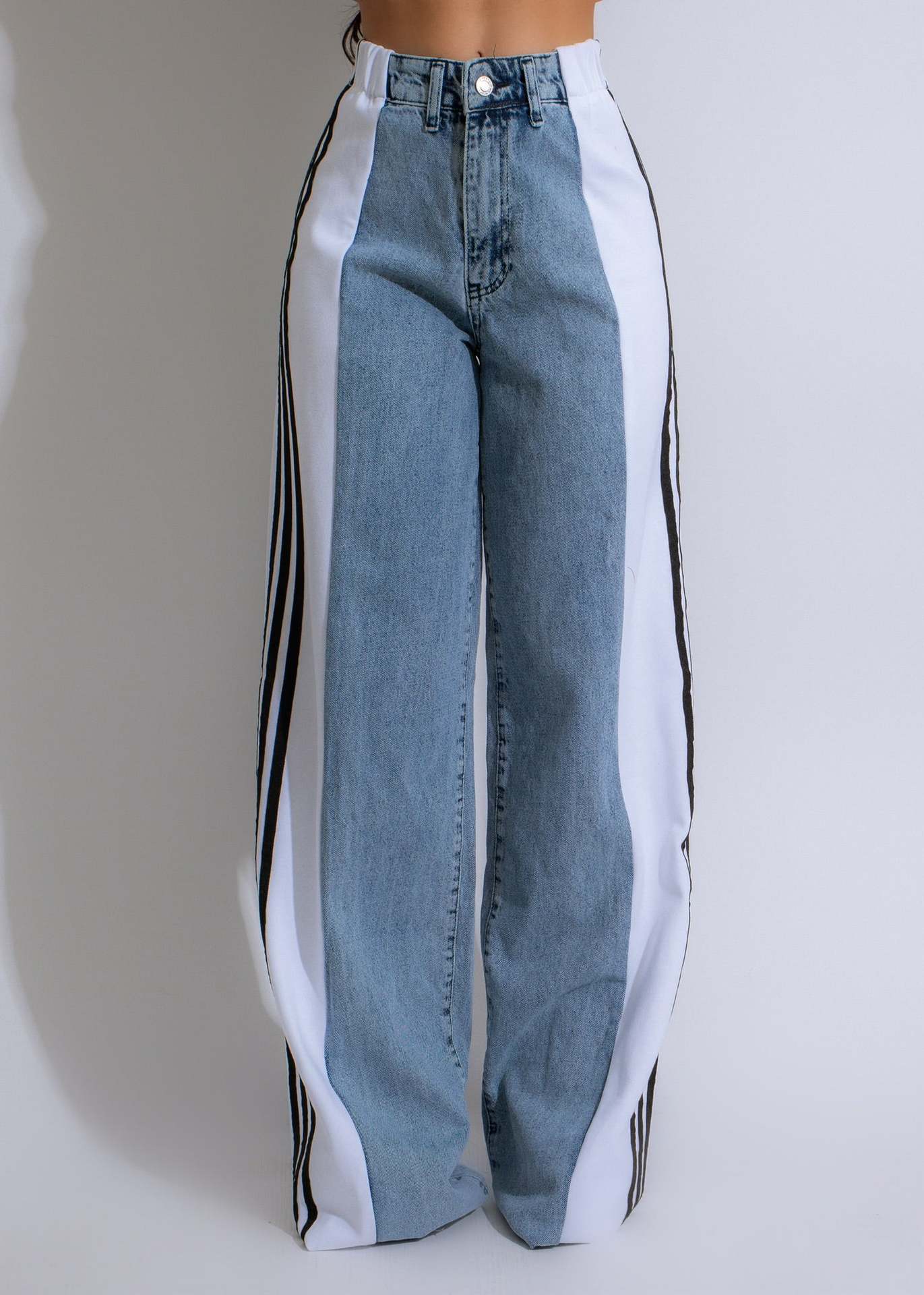 Wide-leg denim jeans with striped side panels, perfect for casual fashion outfits