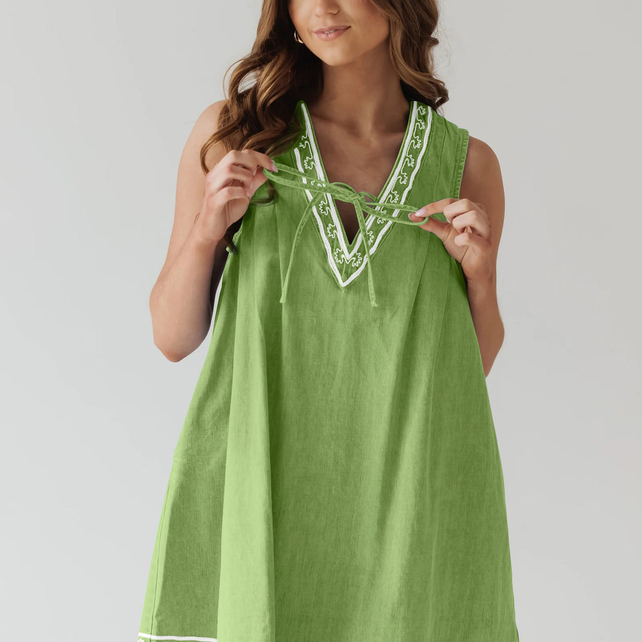 Green sleeveless dress with white trim in Beautiful Embroidered Vest Denim Dress fashion