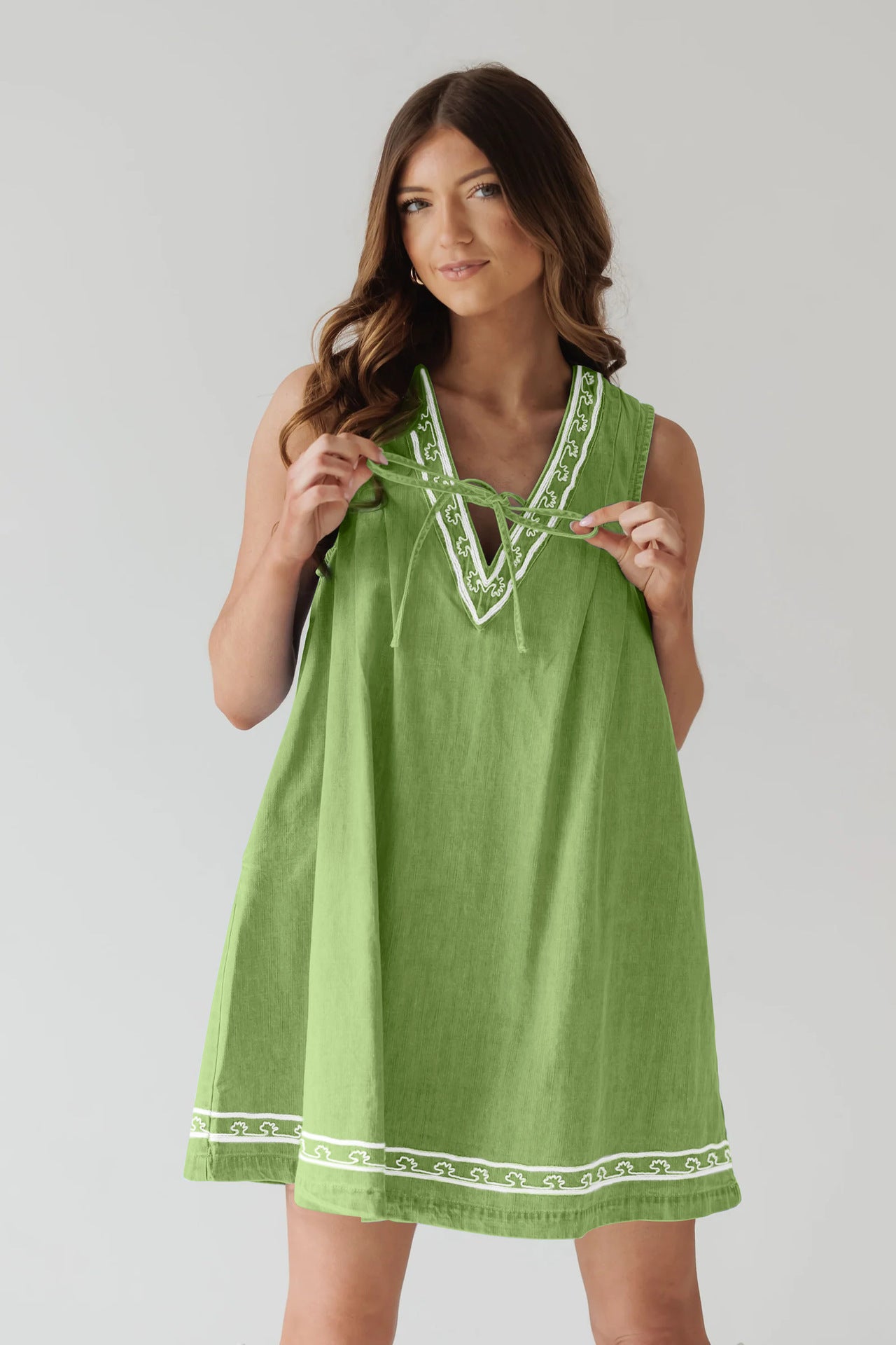 Green sleeveless dress with white trim in Beautiful Embroidered Vest Denim Dress fashion