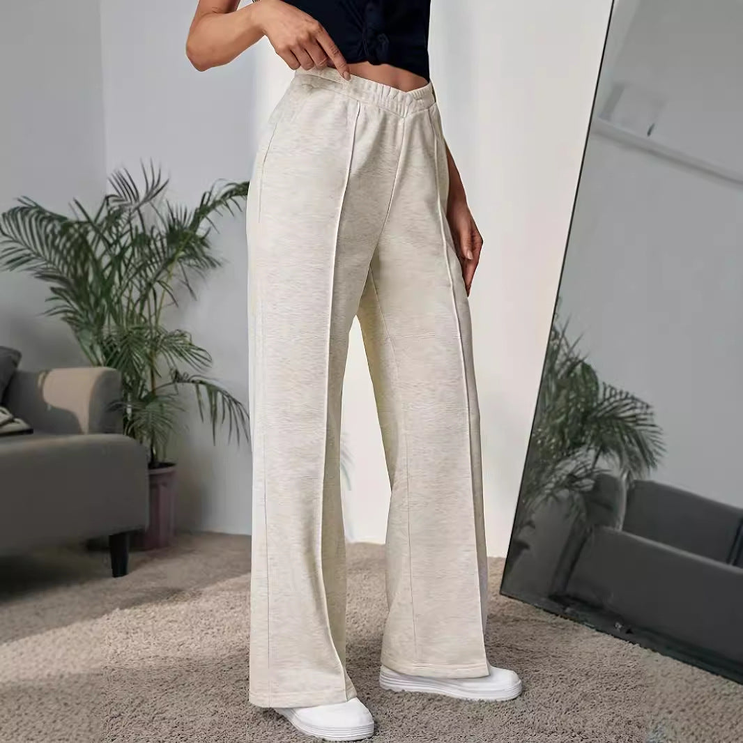 Cream-colored wide leg sweatpants featuring an elastic waistband for stylish comfort