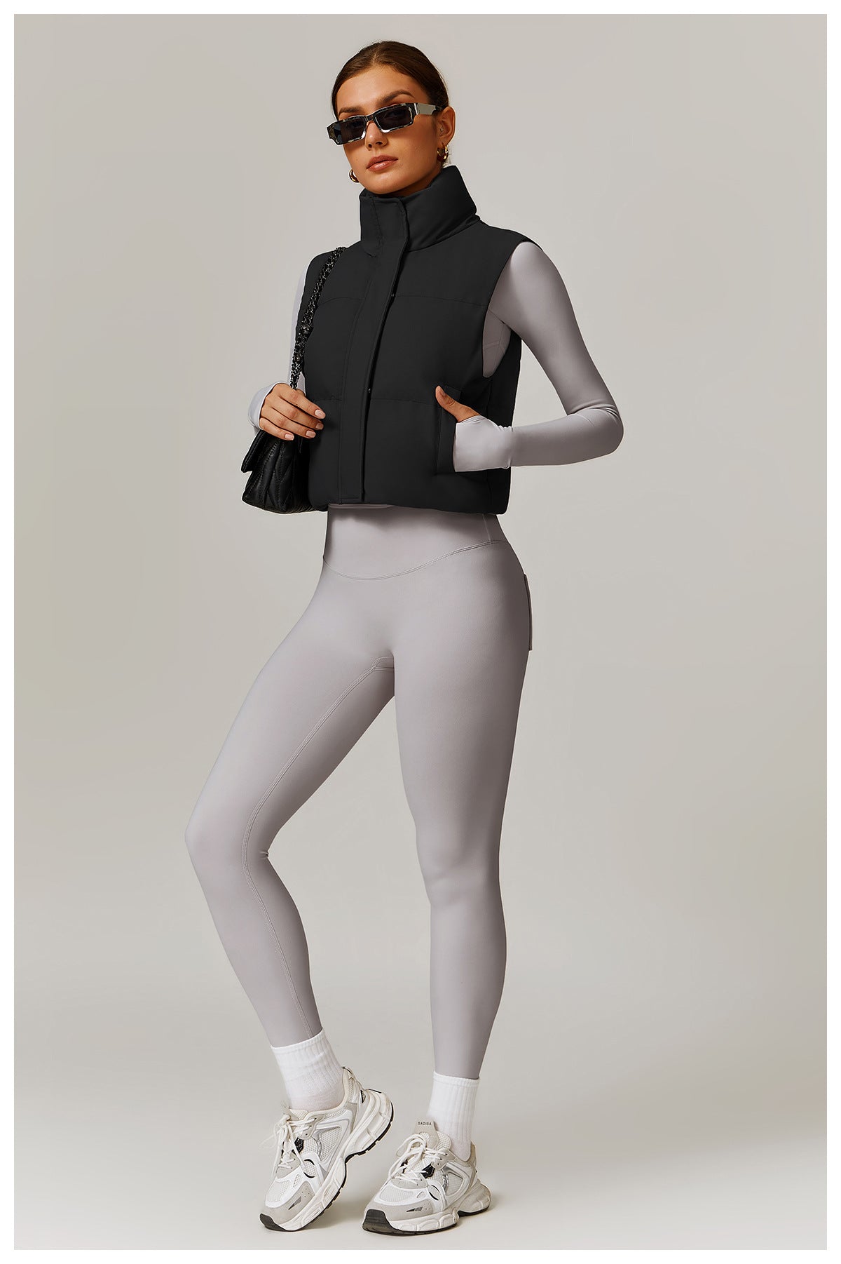 Woman in black puffer vest and gray leggings showcasing Winter Fashionable Warm Vest Coat for stylish ملابس and langry fashion