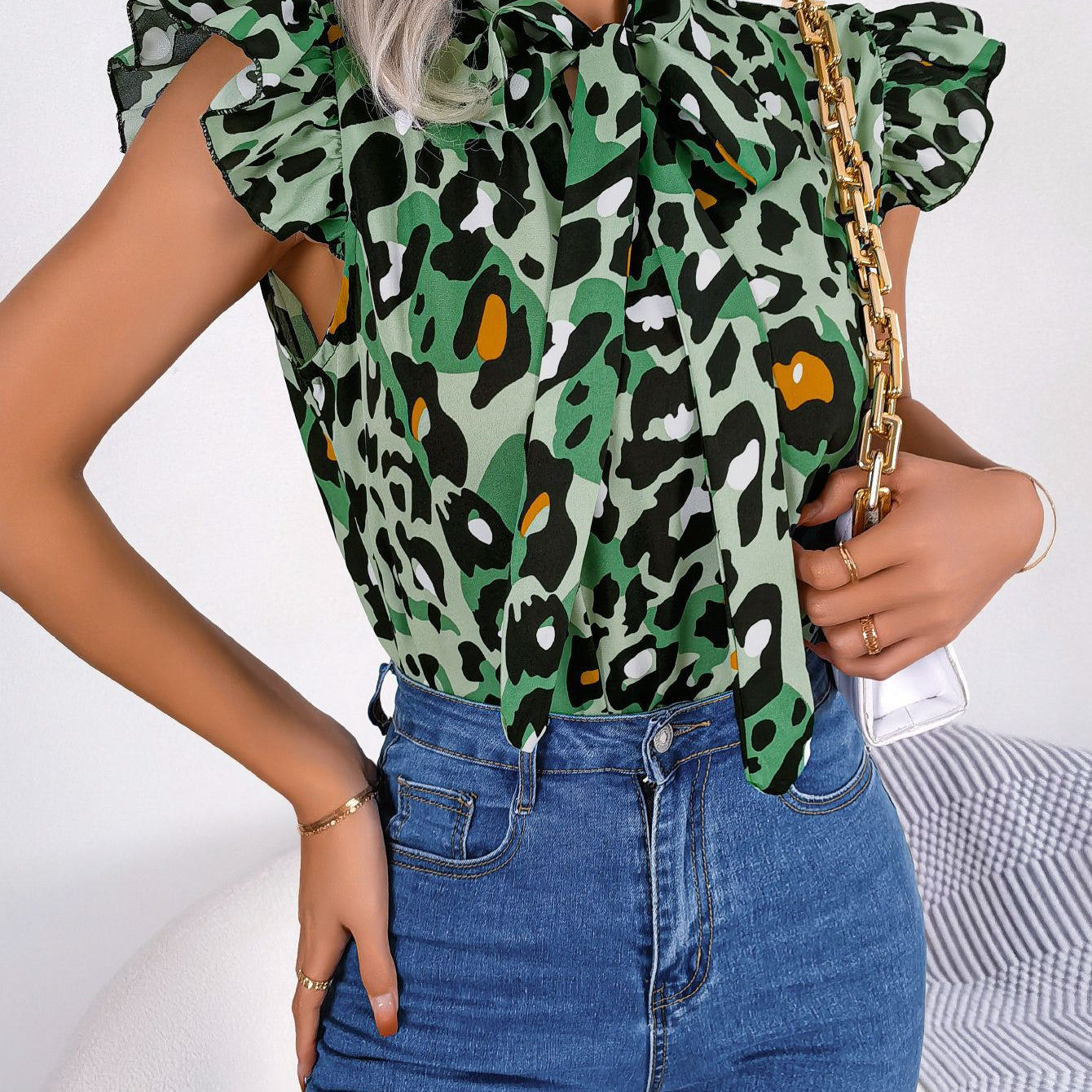 Casual leopard print blouse top with pussy bow neckline paired with blue jeans