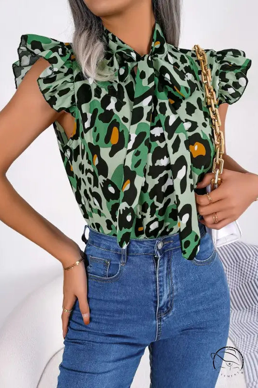 Casual leopard print blouse with pussy bow neckline and blue jeans