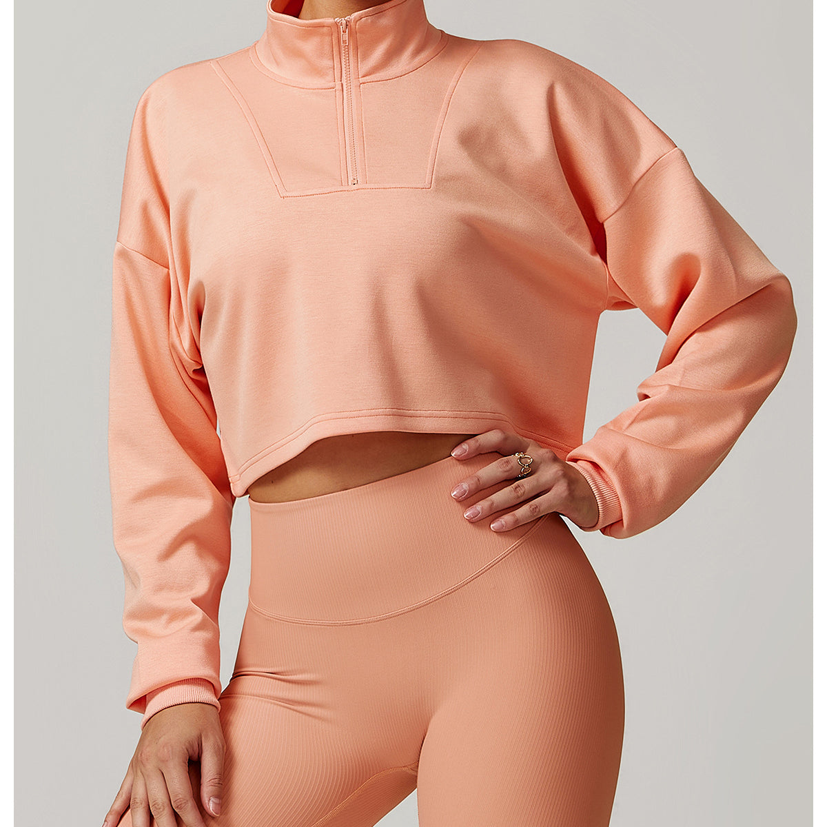 Peach athletic crop top and high-waisted leggings set for stylish winter sports fashion