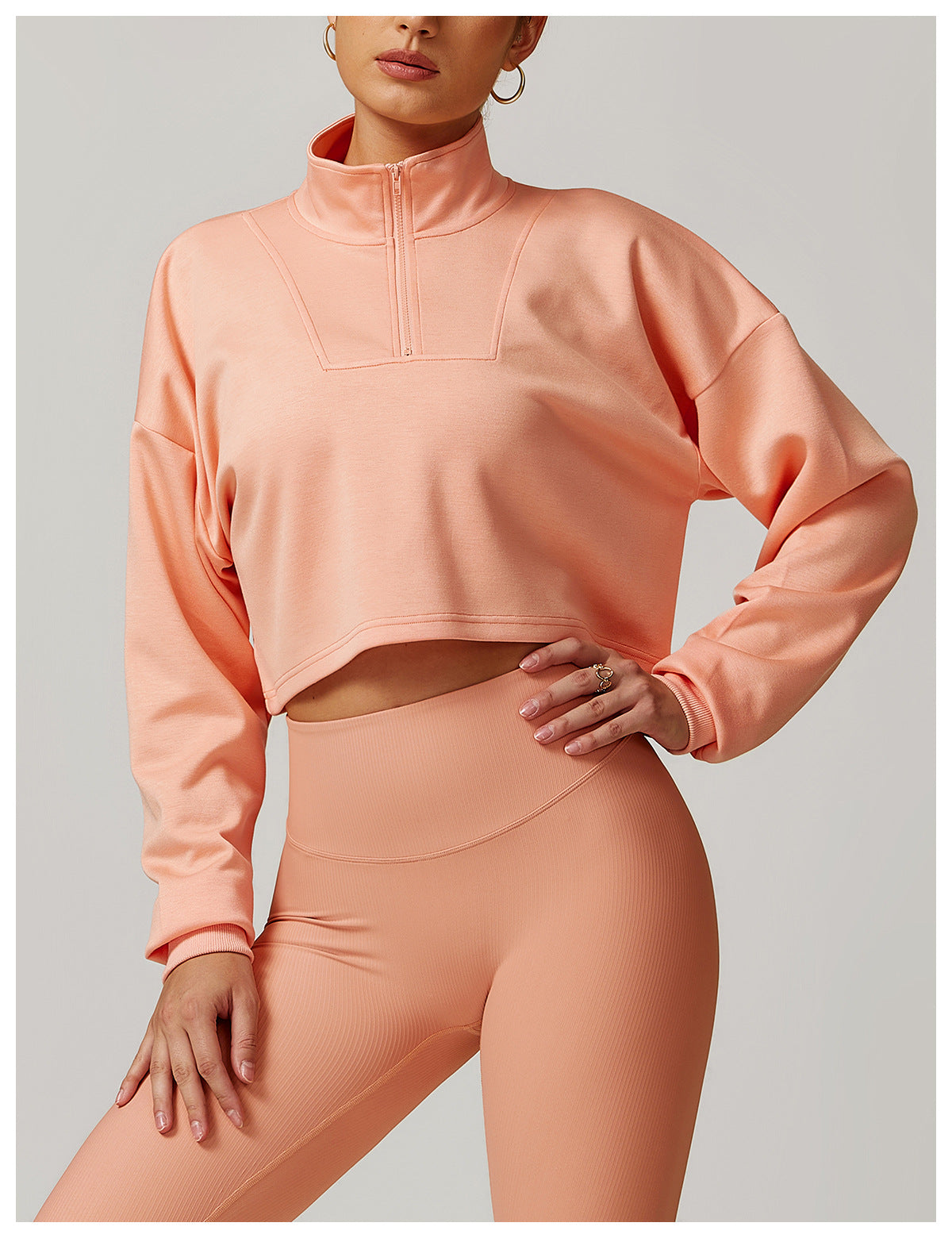Peach athletic crop top and high-waisted leggings set for stylish winter sports fashion