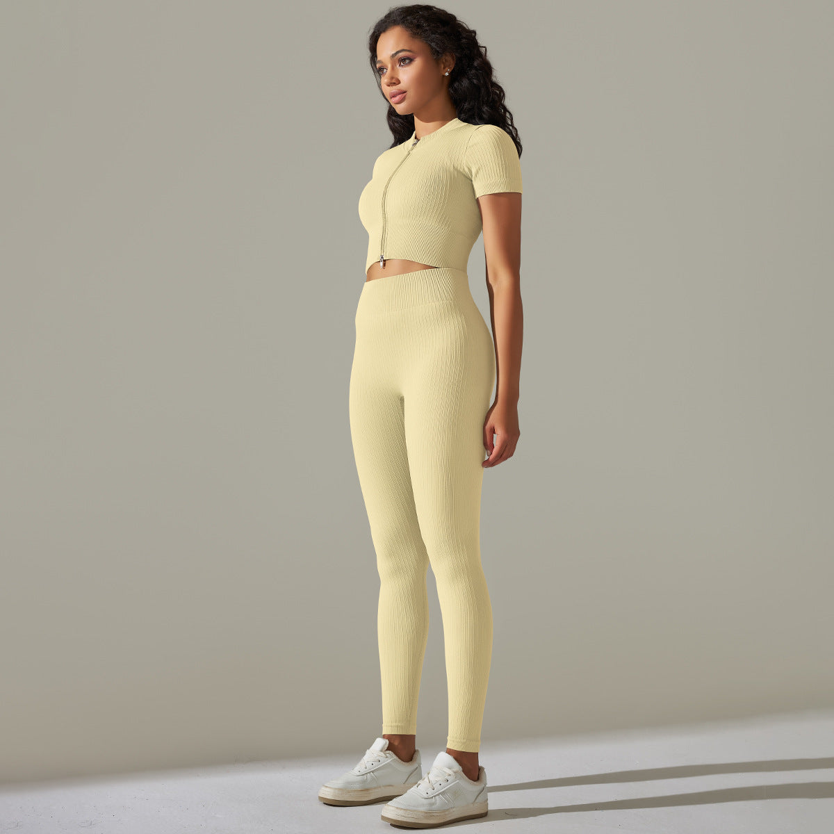 Woman wearing a yellow seamless knitted peach hip high waist yoga set