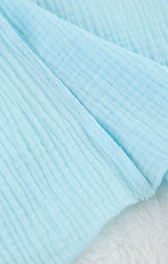 Light blue textured fabric diaper in Langry cotton crepe pajamas