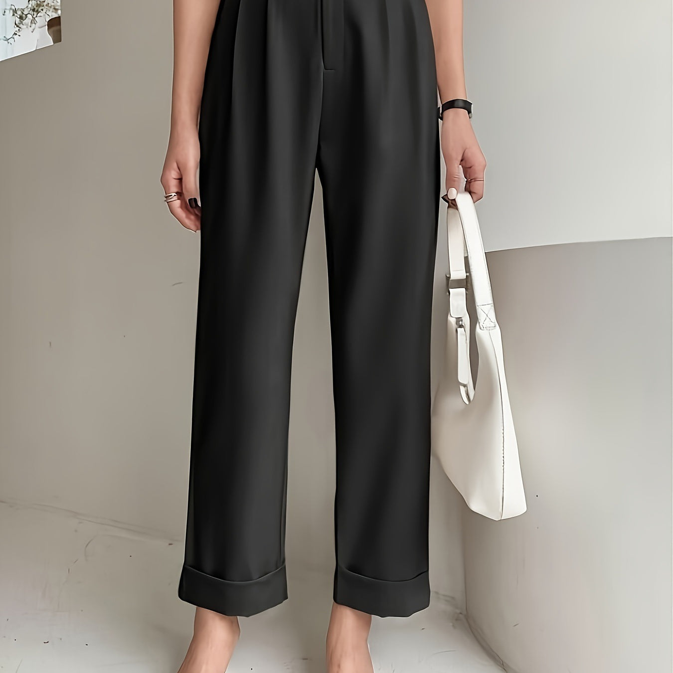 Black high-waisted pleated wide leg pant with rolled cuffs for a stylish office look