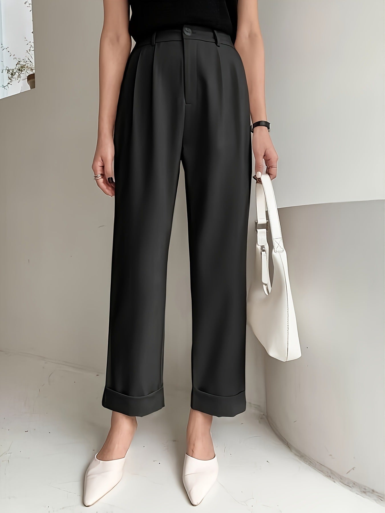 Black high-waisted pleated wide leg pant with rolled cuffs for a stylish office look