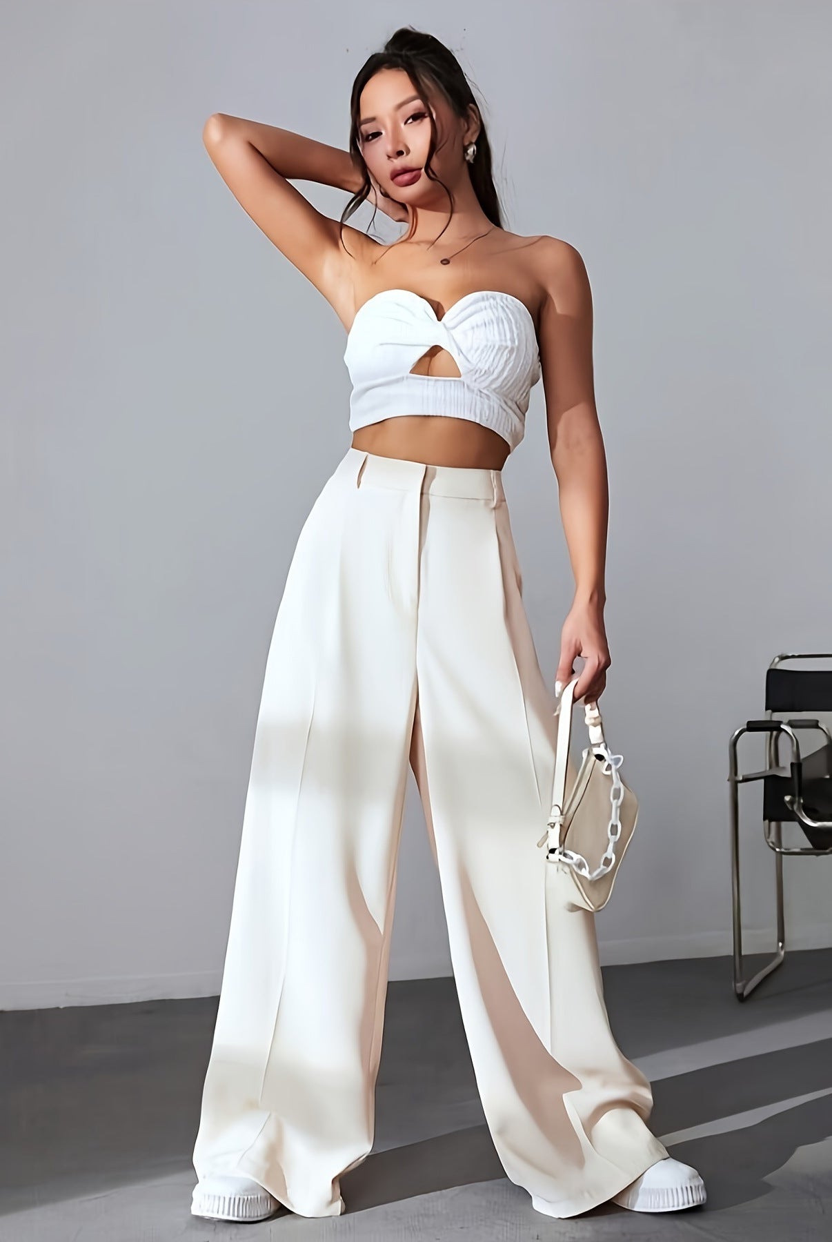 White two-piece fashion set featuring wide leg palazzo pants and a strapless crop top