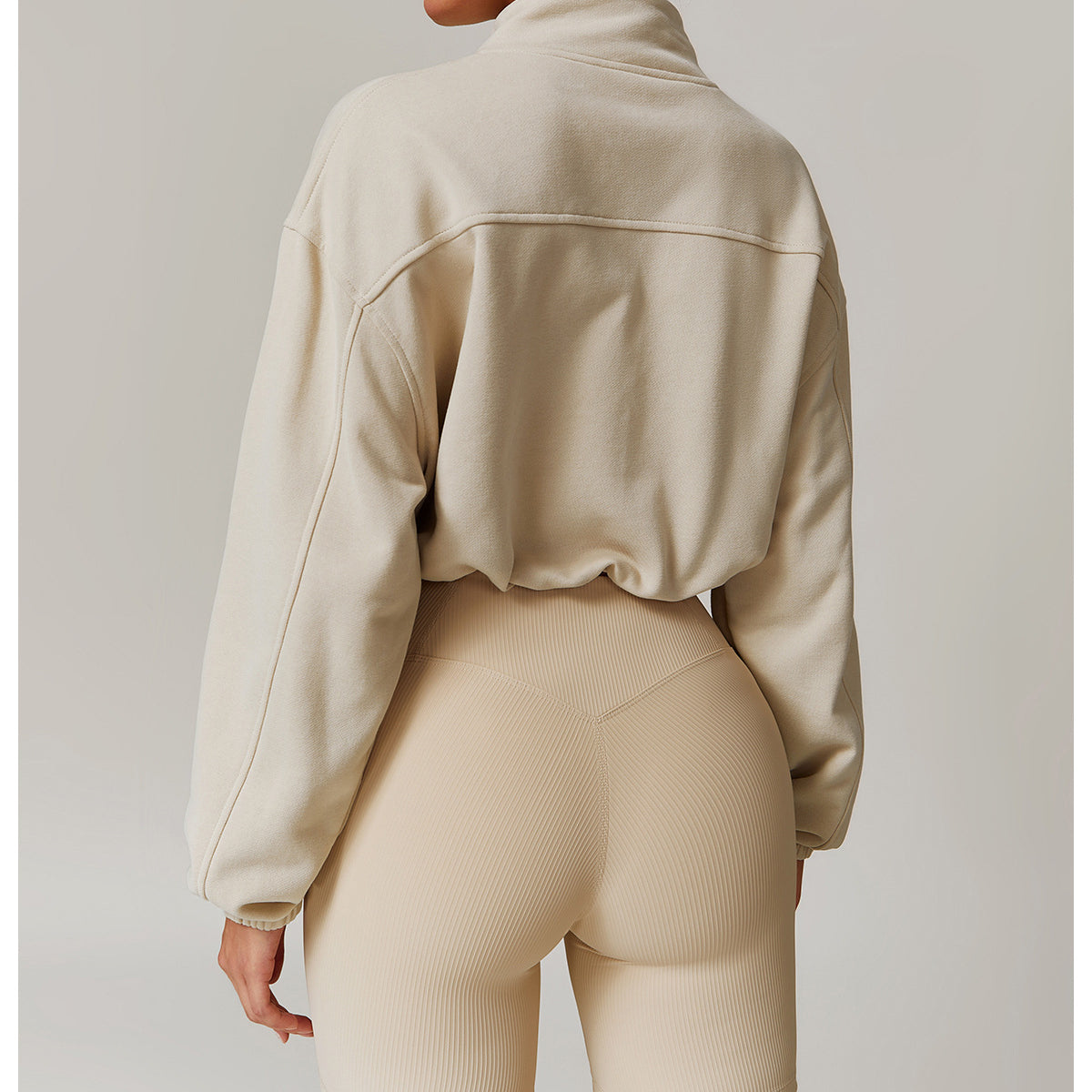 Beige cycling shorts and oversized cream sweatshirt for stylish fall winter sports fashion