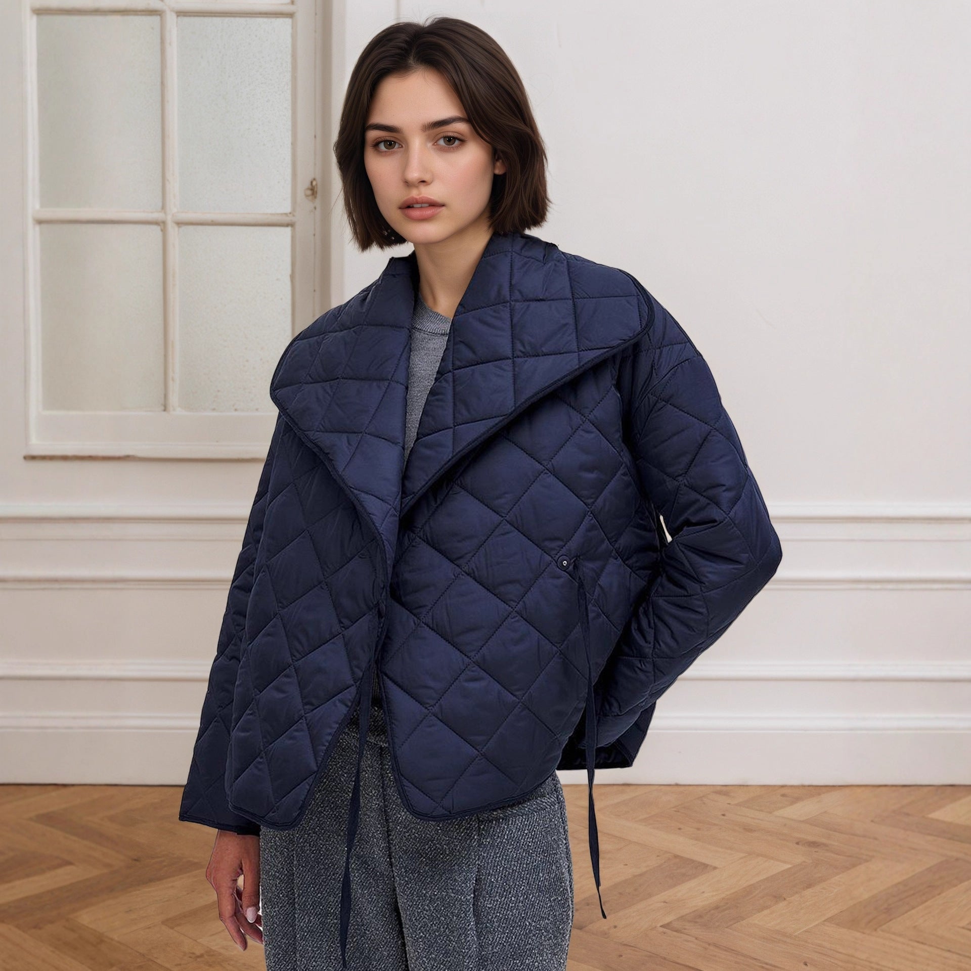 Navy blue quilted cotton padded coat with high collar and drawstring hem
