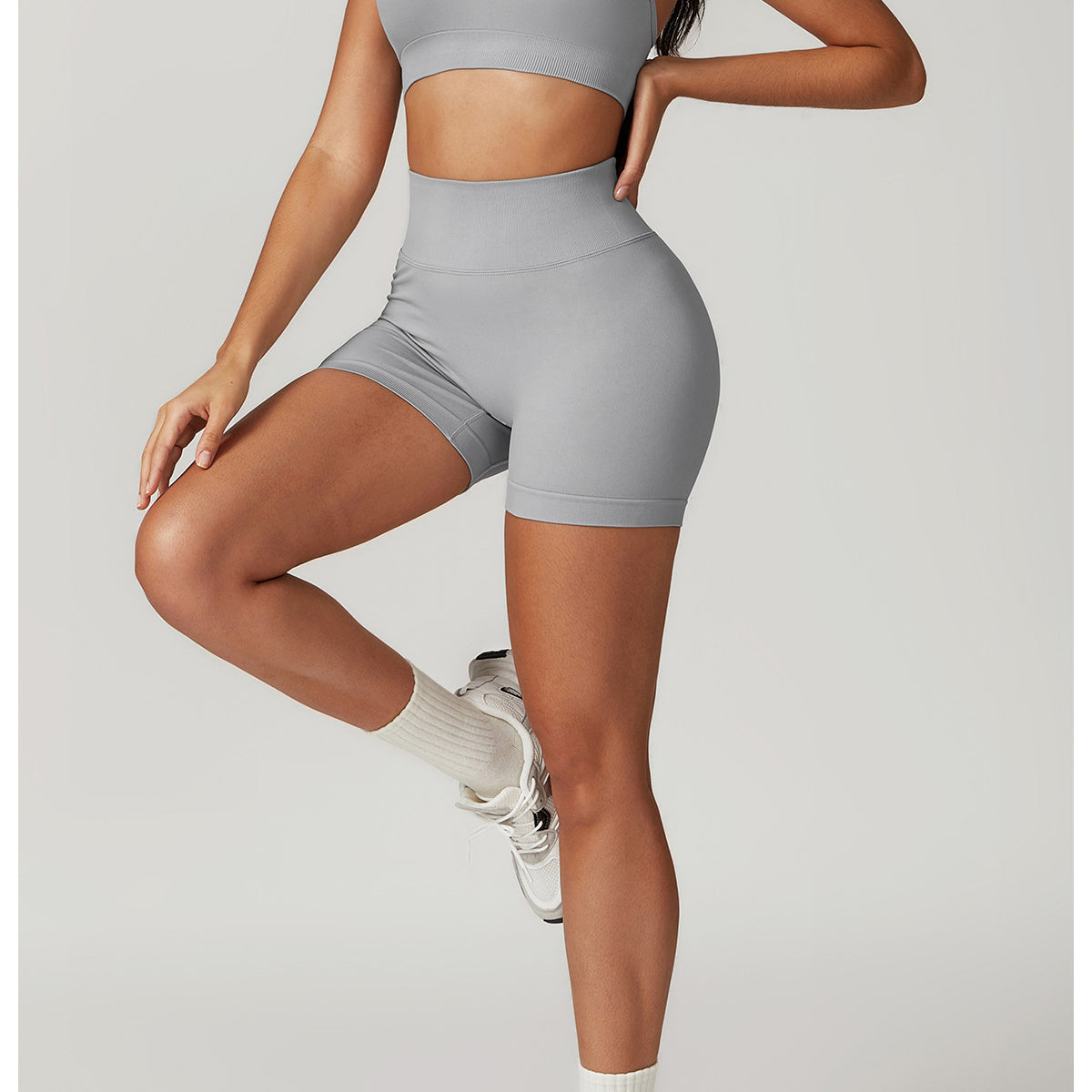 Woman in gray Seamless Yoga Suit featuring bra shorts Rhino style