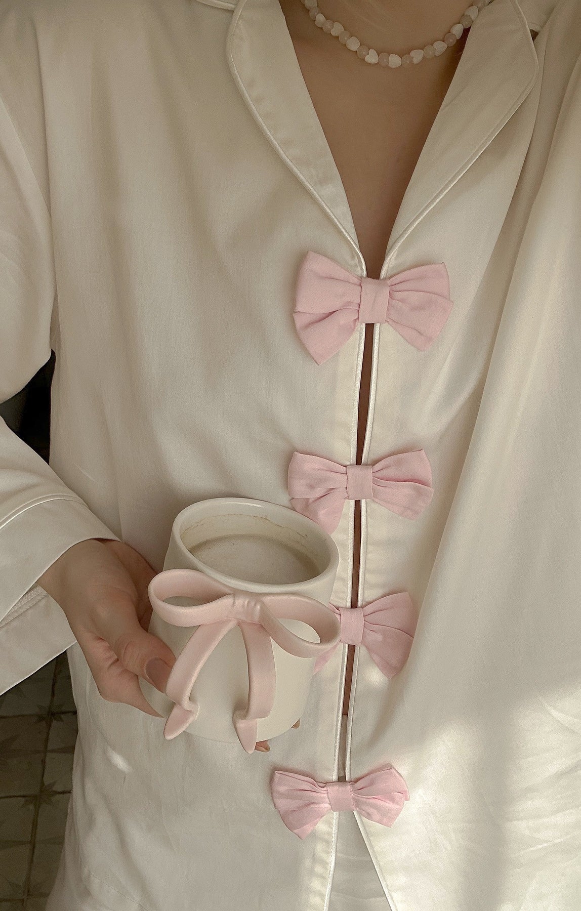 Elegant langry fashion white silk robe with pink bow accents, pearl necklace, pajamas set