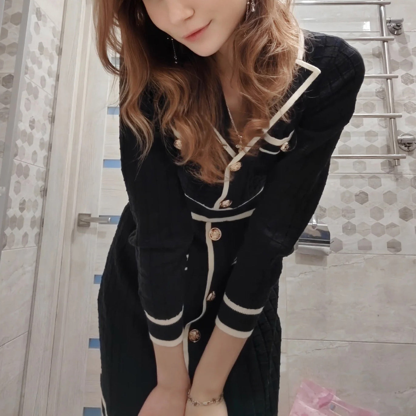 Black knitted classic dress with white trim and gold buttons, elegant classic dress style