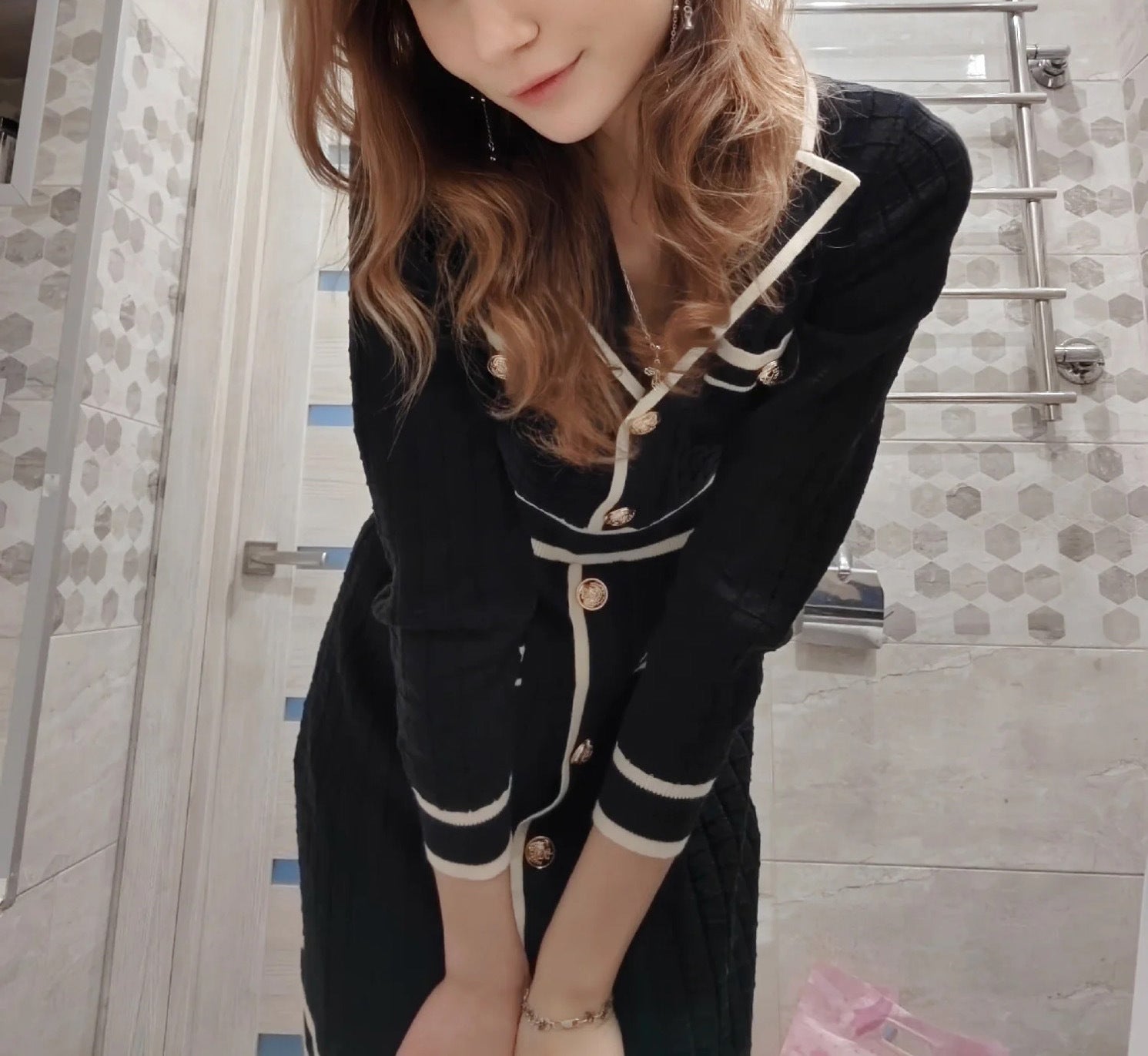 Black knitted classic dress with white trim and gold buttons, elegant classic dress style