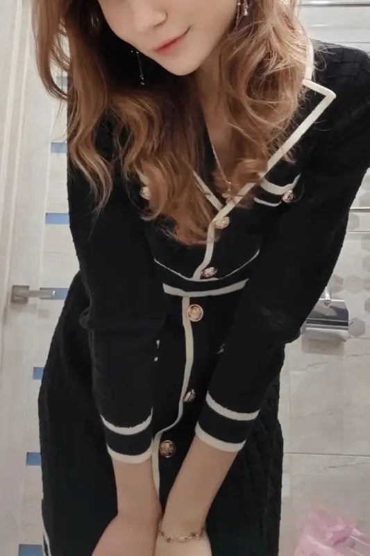 Knitted classic dress in black with white trim and gold buttons