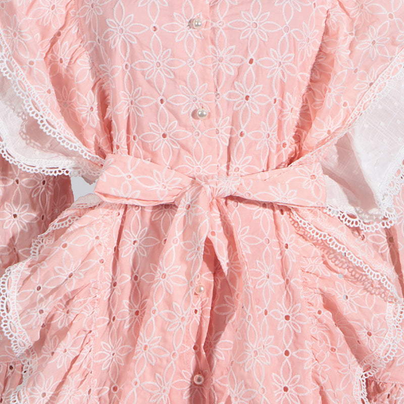 Pink eyelet dress with stand collar, white lace, and tie waist for elegant fashion