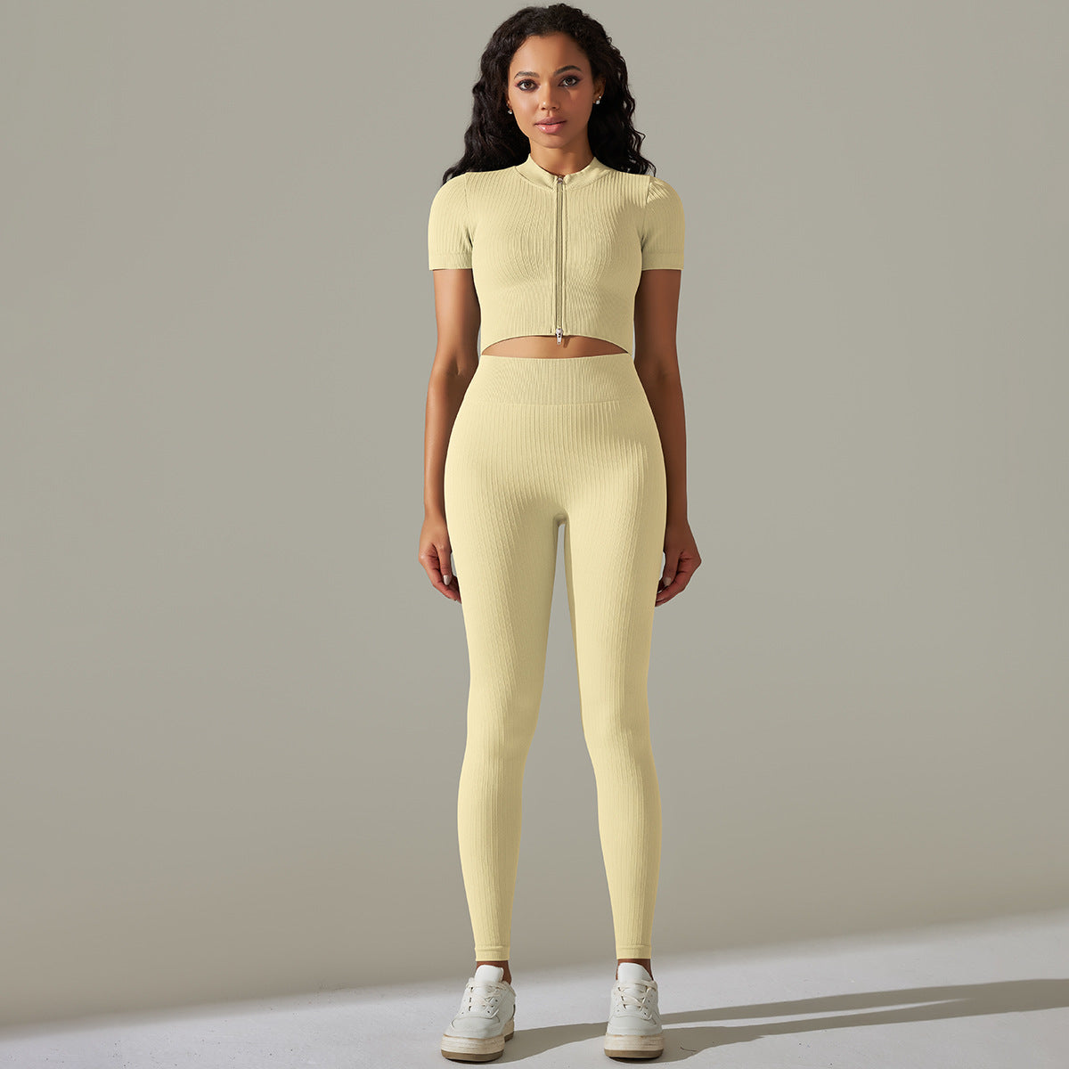 Woman wearing seamless knitted peach hip high waist yoga set in yellow athletic attire