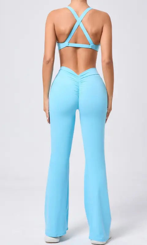 Light blue tight brushed yoga jumpsuit with peach hip raise crisscross back