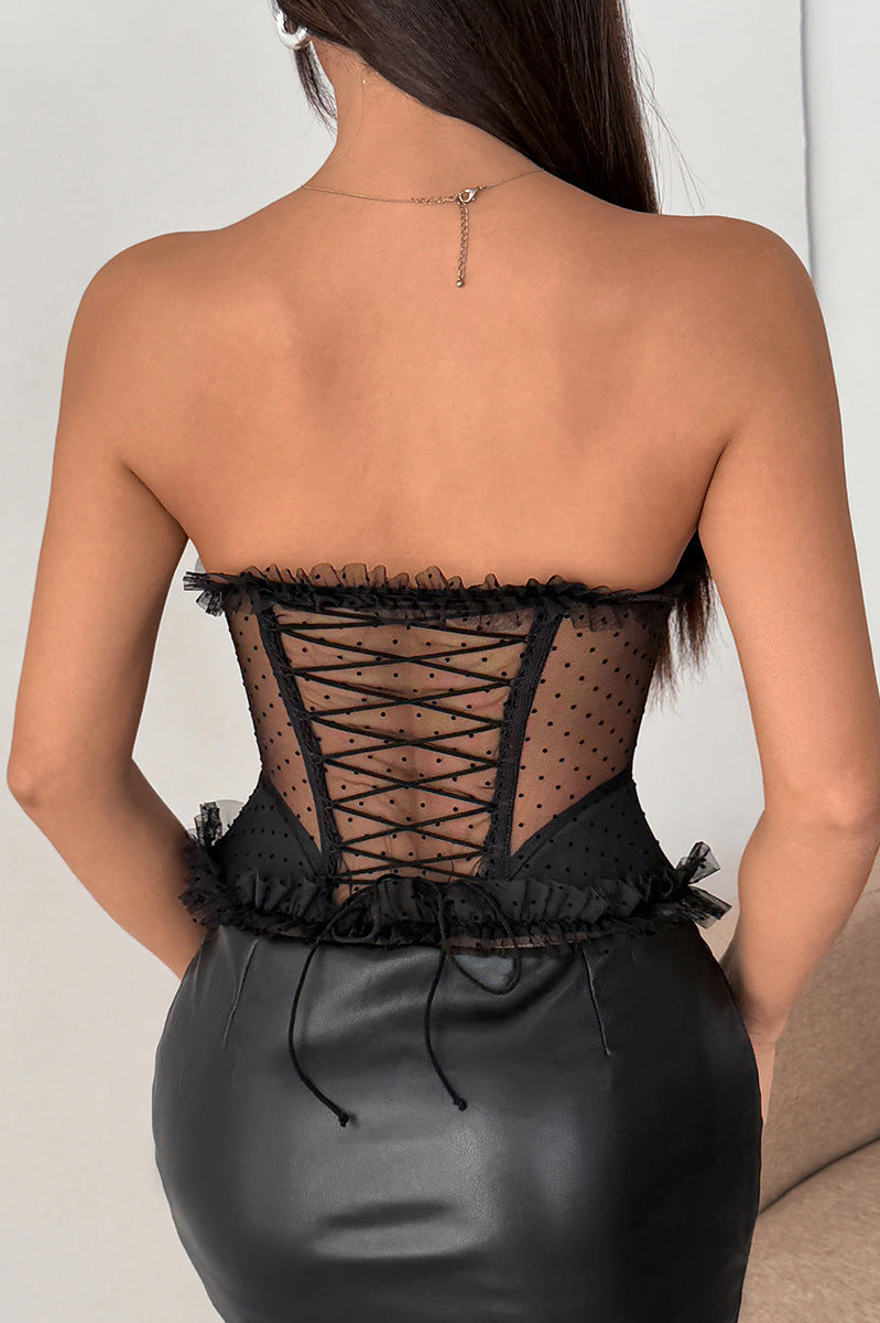 Black strapless polka dot corset dress with lace-up back and ruffled hem