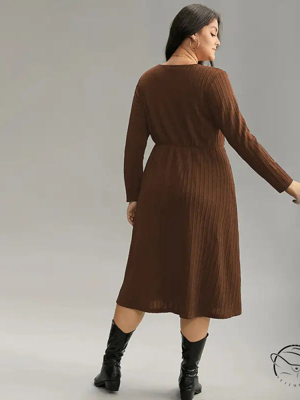 Brown ribbed plus-size long-sleeve midi office dress with elastic waist and black boots