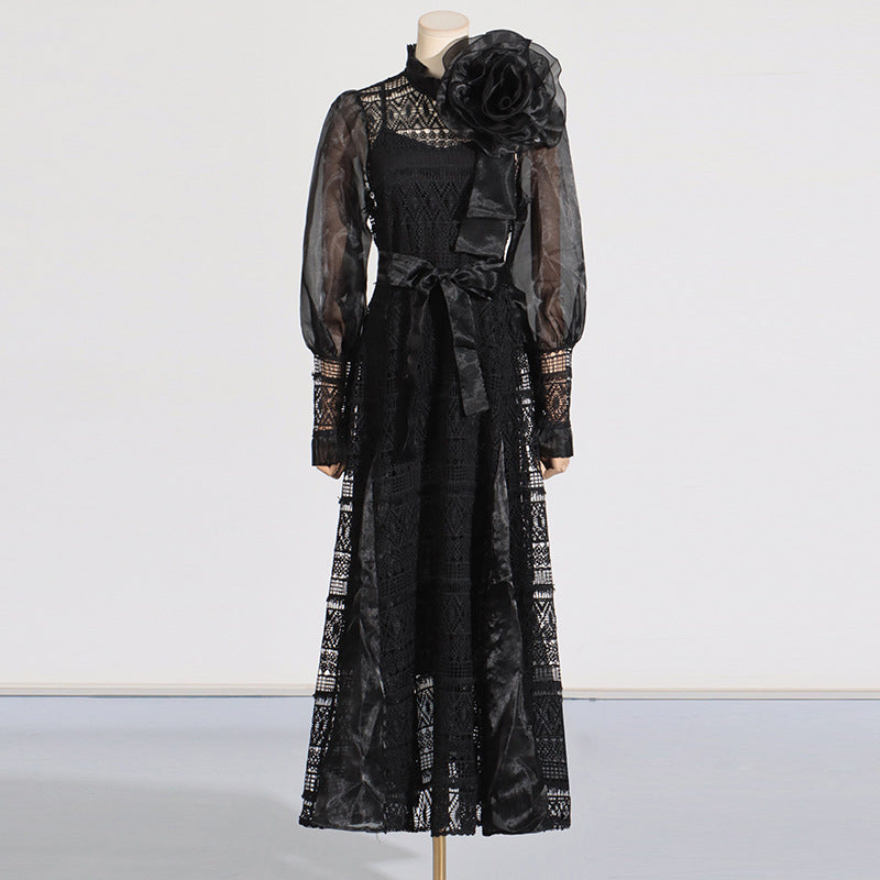 Elegant black lace gown featuring floral embellishments and lantern sleeves in fashion