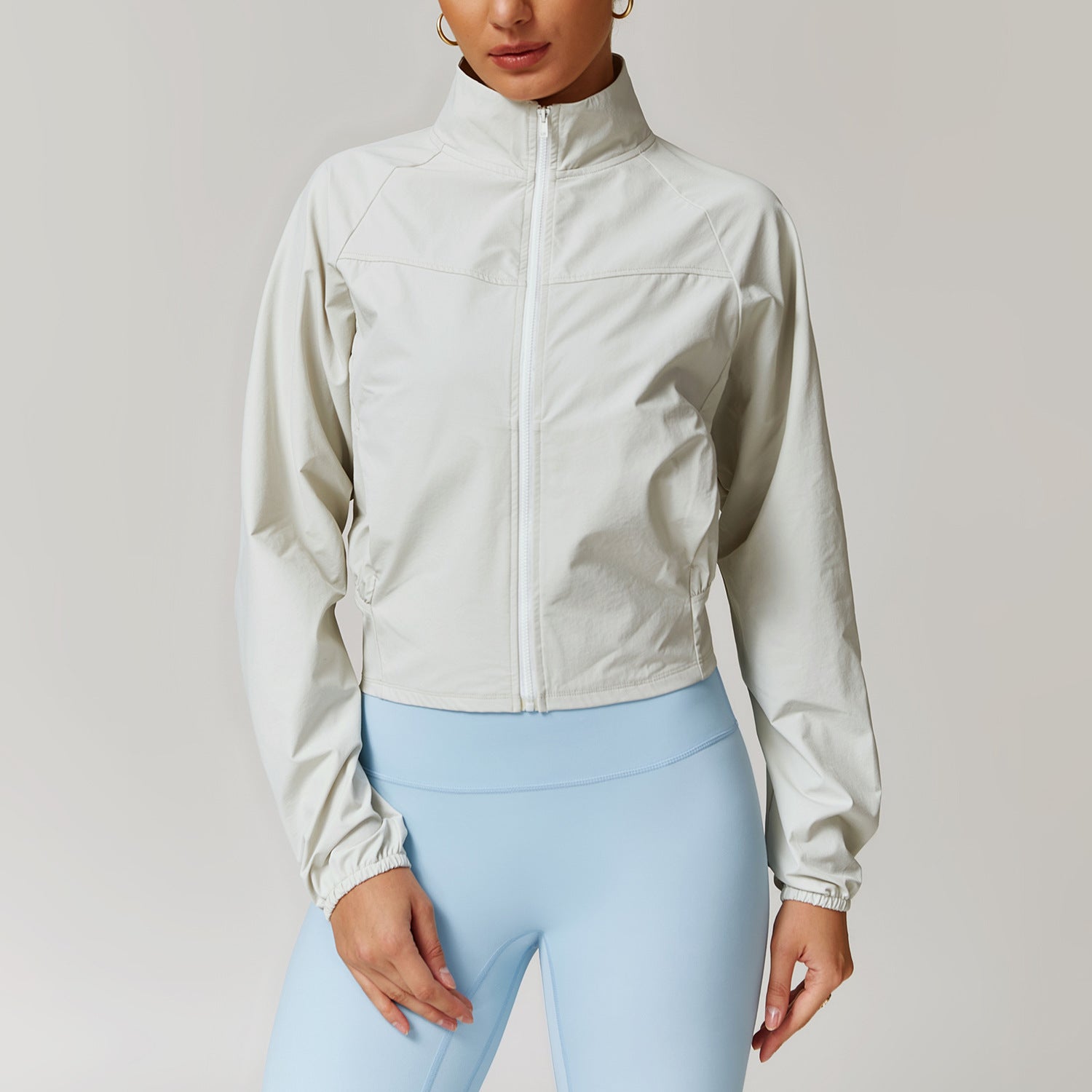White cropped zip-up athletic jacket with a mock neck collar for active fashion and ملابس
