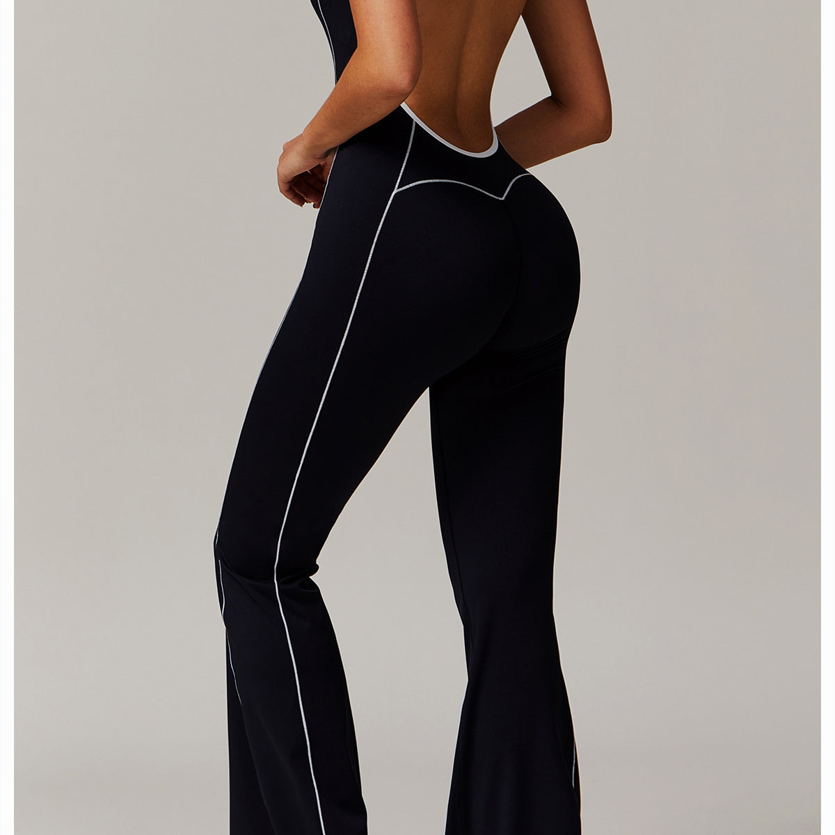 Black open-back jumpsuit with white trim, perfect for stylish langry fashion choices