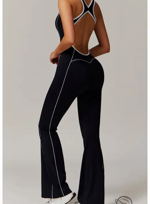 Black open-back Langry yoga jumpsuit with white trim and pleats