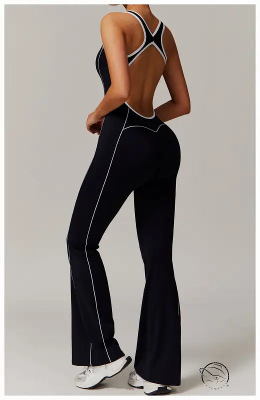 Black open-back Langry yoga jumpsuit with white trim and pleats
