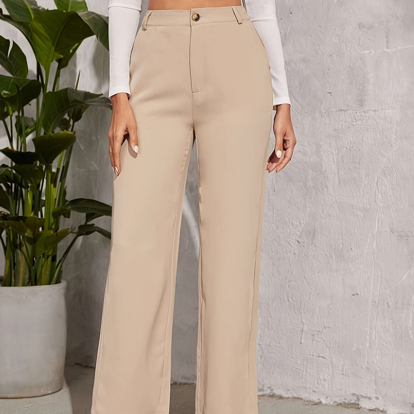 High-waisted beige wide-leg trousers featuring button closure for elegant fashion ملابس