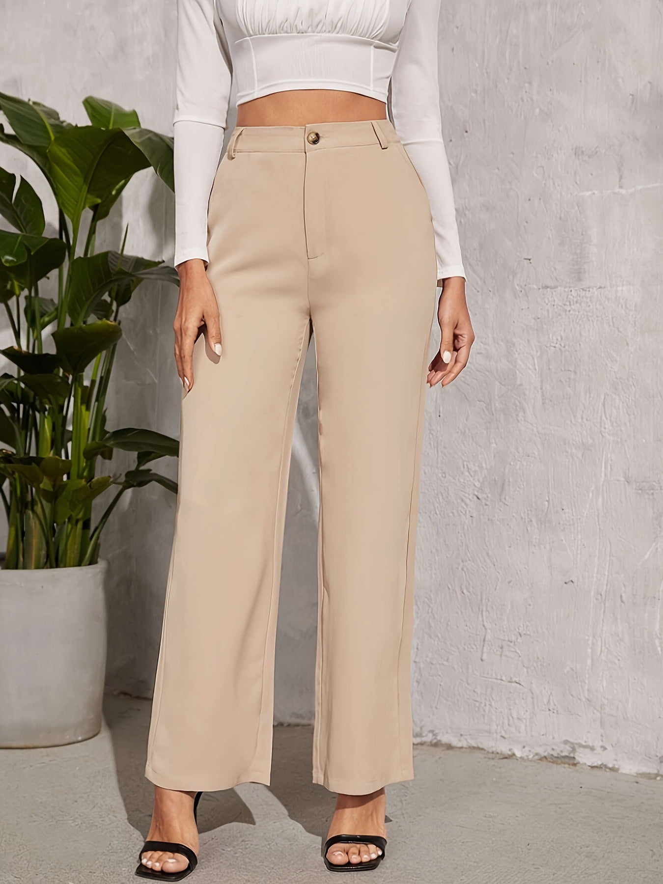 High-waisted beige wide-leg trousers featuring button closure for elegant fashion ملابس