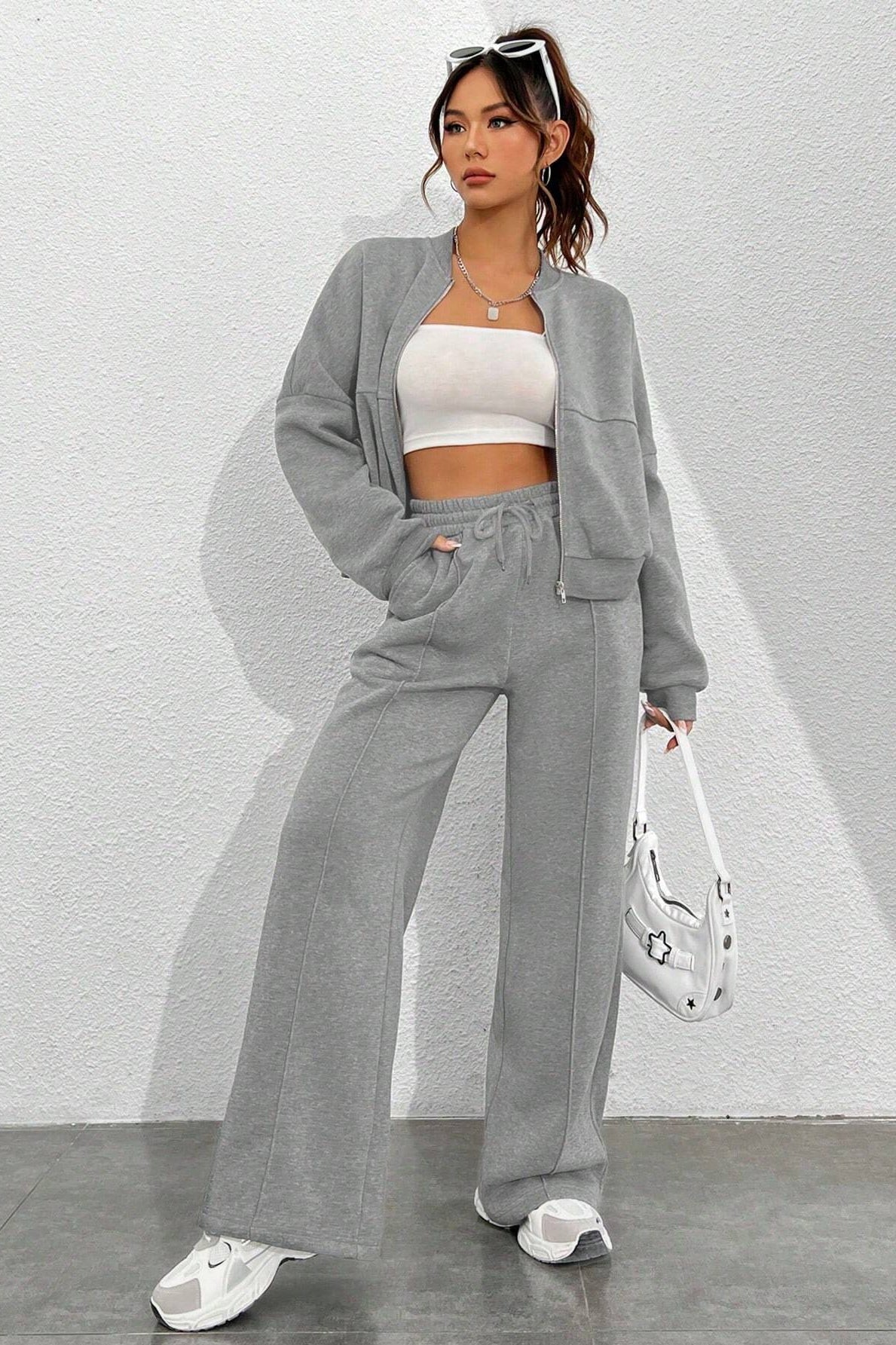 Woman in gray tracksuit showcasing Trendy Cardigan Two Piece Set for stylish ملابس