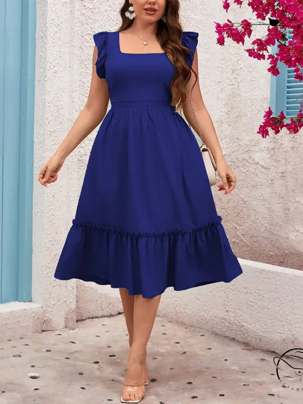 Woman in royal blue vacation casual midi dress with ruffles