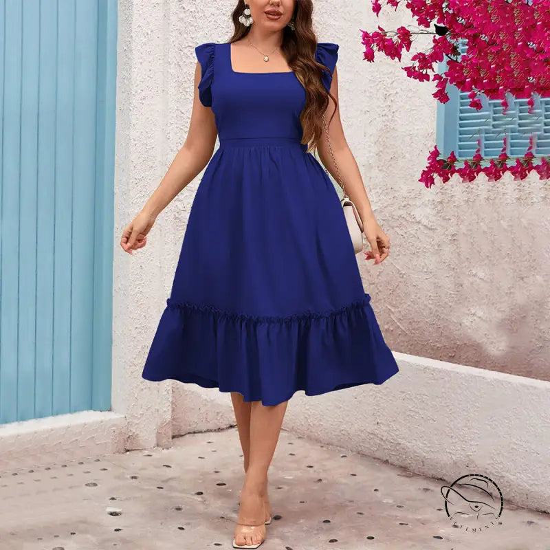 Woman in royal blue vacation casual midi dress with ruffles