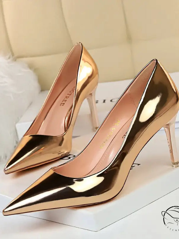 Shiny pair of fashionable gold stiletto heels