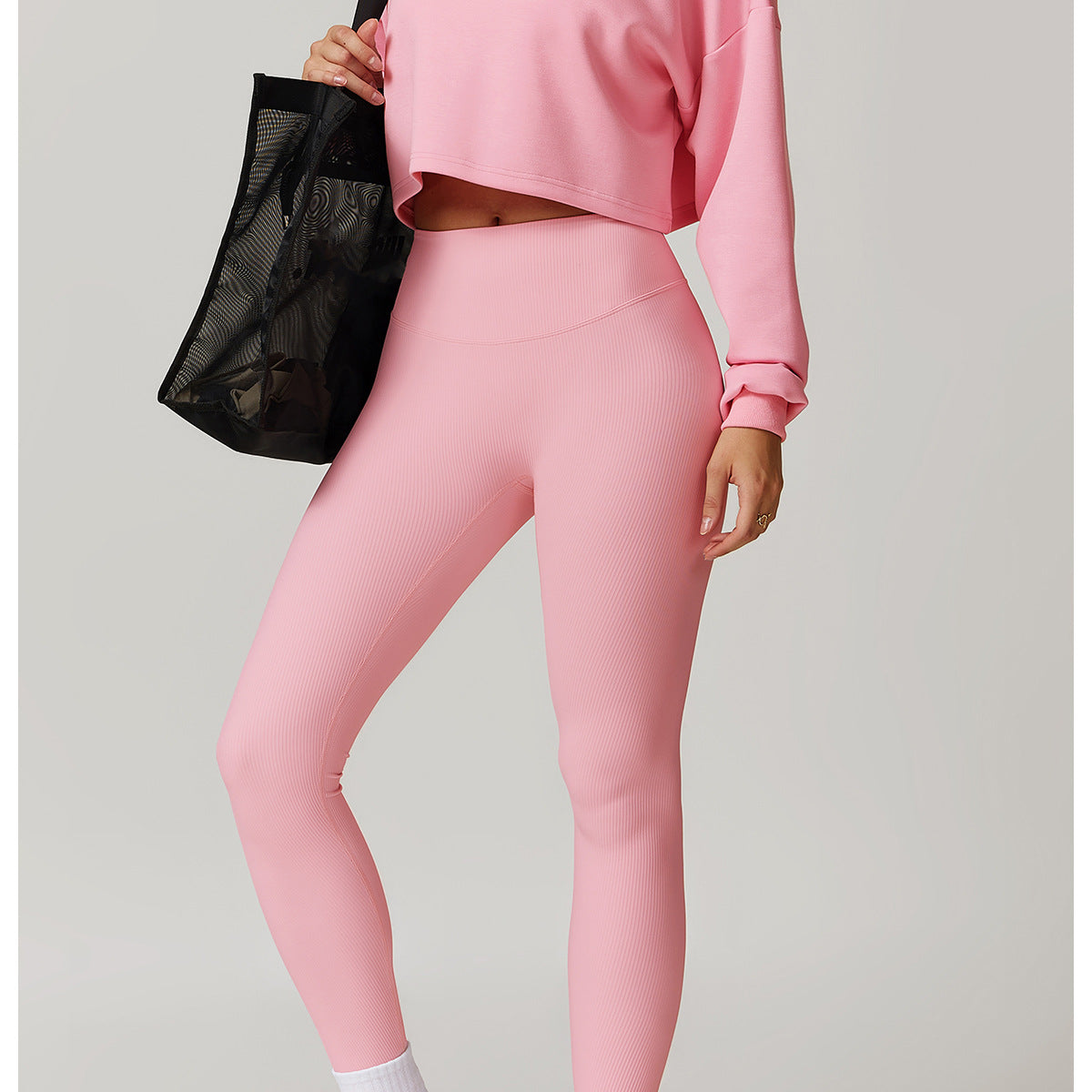 Pink cropped turtleneck and leggings set with white sneakers, perfect for Winter Wild fashion